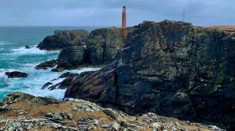 Dramatic coastal view of the Butt of Lewis Lighthouse on a rocky outcrop, showcasing the rugged Wildlife of Harris and Lewis.